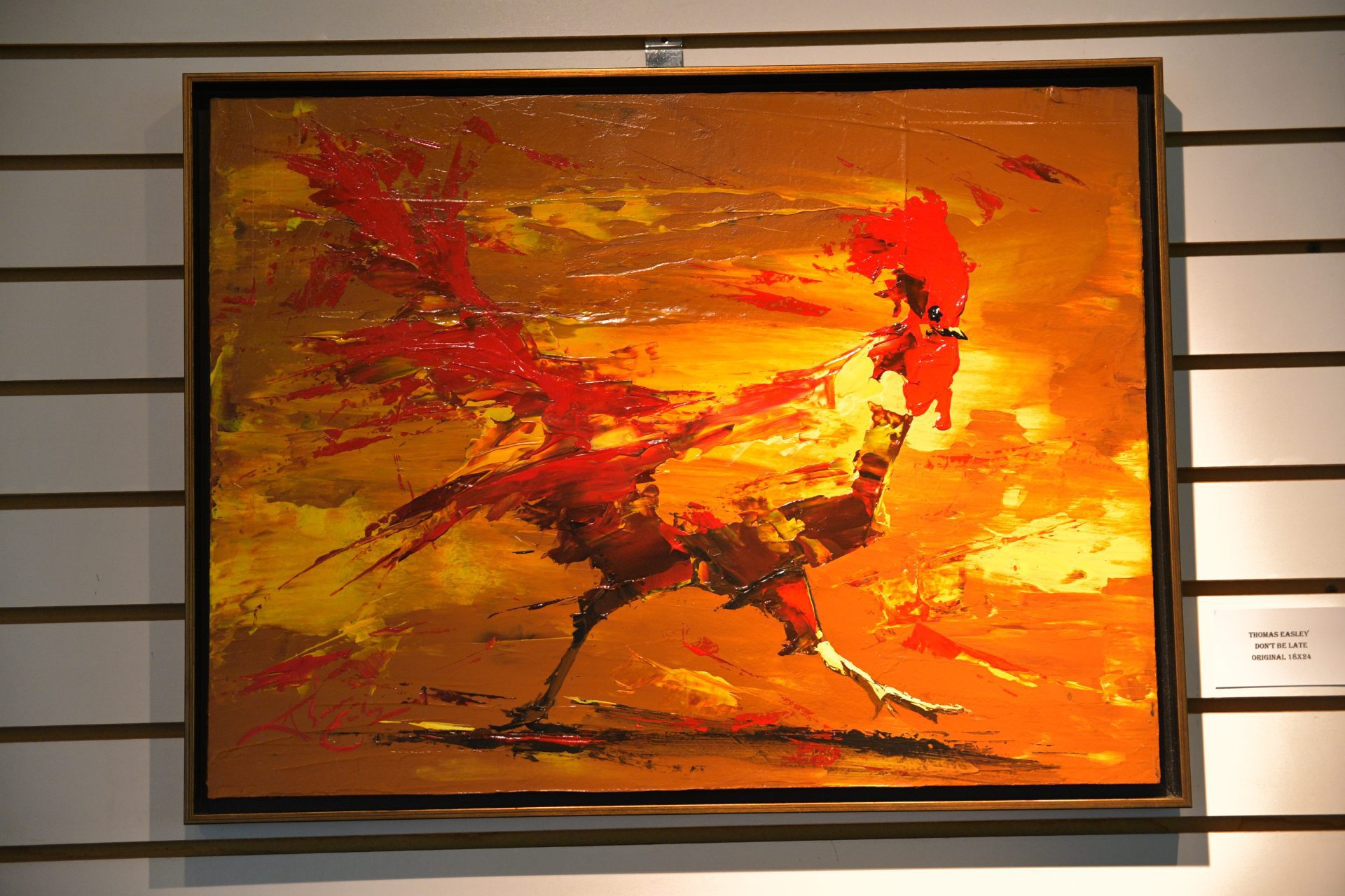 A painting of an orange and red bird.